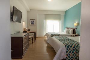 Voodi või voodid majutusasutuse HG Hotel toas