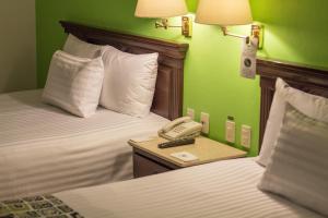 Voodi või voodid majutusasutuse HG Hotel toas