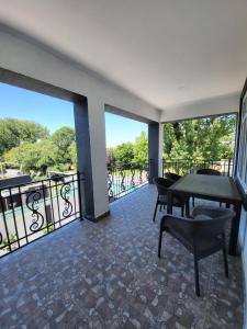 a room with a balcony with a table and chairs at Gabala Deluxe 4-bedrooms Villa in Gabala