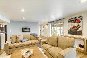 a living room with two couches and a table at Steps to Clark Lake Cozy Apartment with Hot Tub in Clarklake