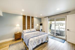 a bedroom with a bed and a large window at Steps to Clark Lake Cozy Apartment with Hot Tub in Clarklake