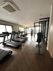 a gym with a row of treadmills and chairs in a room at Flat Mirant Vila Madalena in São Paulo
