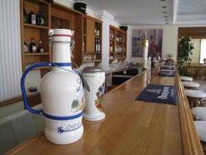 two white vases sitting on a counter in a bar at Nafsika Hotel in Rhodes Town