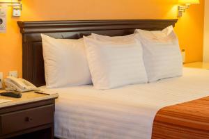 Voodi või voodid majutusasutuse HG Hotel toas