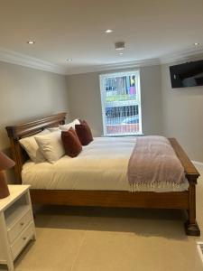 a bedroom with a large bed with a window at Derry City Apartment in Derry Londonderry
