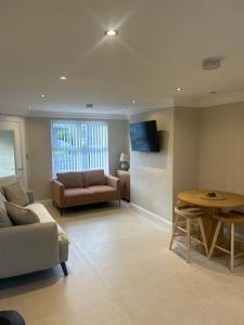 a living room with a couch and a table at Derry City Apartment in Derry Londonderry