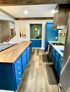 a kitchen with blue cabinets and a wooden counter top at Copper Cottage French Lick in French Lick