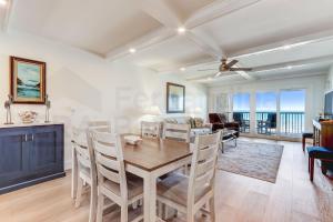 a dining room and living room with a table and chairs at High End Coastal Feel Condo in Fernandina Beach