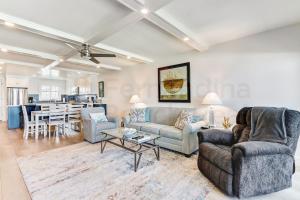 a living room with two couches and a table at High End Coastal Feel Condo in Fernandina Beach