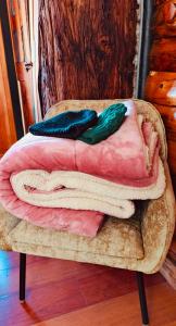 a pile of blankets sitting on a wooden table at Cabaña en La Calera con Jacuzzi in La Calera +58 photos