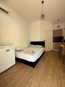 a bedroom with a bed and a refrigerator at Apartments Maja in Neum