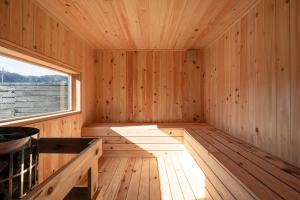 an empty wooden sauna with a large window at 富士山望むプライベートヴィラ 900平方メートルの敷地を貸切利用 憩 ikoi Fuji サウナ 4Kシアター in Fujikawaguchiko
