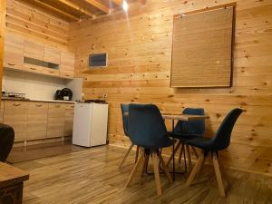 a kitchen with a table and chairs and a refrigerator at Cottage Four Olives in Ulcinj