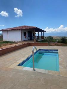 a large swimming pool in front of a house at Casa Hotel Villa Ronda in Barichara