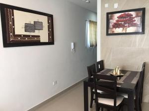 a dining room with a black table and chairs at Comfortable Durango Apartment in Durango