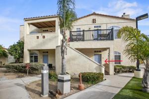 a house with a palm tree in front of it at 444 Pier Ave. #403 in Oceano