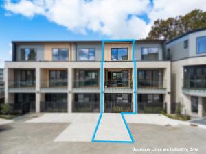 a building with a blue line in front of it at Seabliss Retreat in Auckland