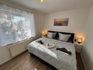 Ένα ή περισσότερα κρεβάτια σε δωμάτιο στο Haus Ostseesprung - Fewo Sarah Hochparterre gratis WLAN, Parkplatz und gem Garten