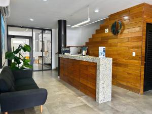 a lobby with a counter and a chair at condesa 12 sublime depa a 100 pasos de la playa in Mazatlán +19 photos