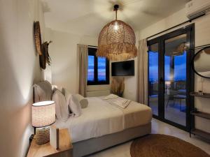 a bedroom with a bed and a large window at Villa in Sfakaki with Pool near Beach in Sfakaki +23 photos