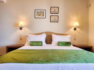 a bedroom with a large bed with two green pillows at Villa in Hersonissos by Sandy Beach & Pool in Hersonissos +22 photos
