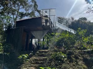a house with a staircase leading up to it at Eco Cabaña en el Campo in La Vega