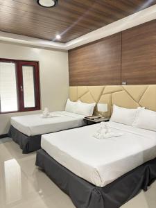 a hotel room with two beds in a room at Hacienda Angelita Nature Farm and Resort in San Rafael +10 photos