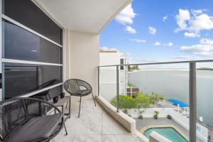a balcony with a view of the ocean at Pumicestone Passage Waterfront Escape in Caloundra