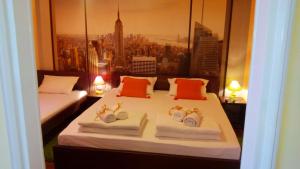 a hotel room with two beds with hats and towels at Balkan-inn Skadarlija 2 apartment in Belgrade
