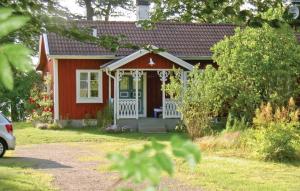 a small red house with a white door at Holiday Home Sjöhagen Ljungby in Bolmstad