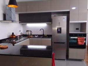 a kitchen with a stainless steel refrigerator and a stove at Tu estadía perfecta en La Paz in La Paz
