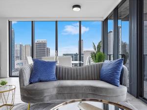 a living room with a couch and large windows at X- Lounge V - High-Rise with Rooftop Pool in Downtown Miami in Miami