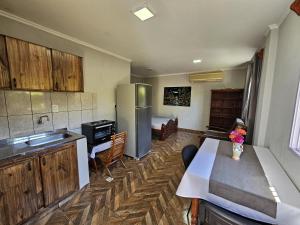 a kitchen with a refrigerator and a table in it at Agradable Monoambiente en posadas in Posadas