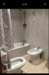 a bathroom with a toilet and a tub and a sink at Beautiful apartment Pontevedra in Sanxenxo