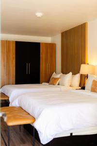 two beds sitting next to each other in a room at Angoria Hotel in San Angelo +41 photos