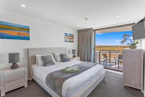 a bedroom with a bed and a balcony at Trafalgar Towers in Maroochydore +203 photos