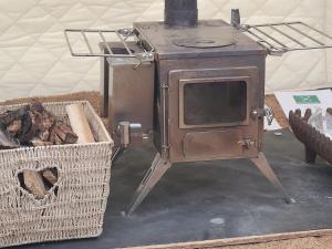 an old stove sitting next to a basket at The Riverside Retreat in Blakeney