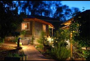 a small house with lights on in the yard at בקתות באהבה בוטיק in Rosh Pinna