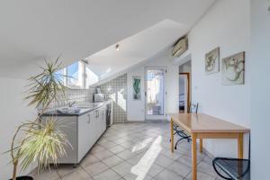 a kitchen with a table and a dining room at Pink Inn in Podstrana