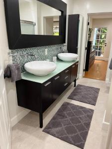 a bathroom with two sinks and a mirror at Stunning, Quiet Vista Retreat Minutes from Beach in Vista