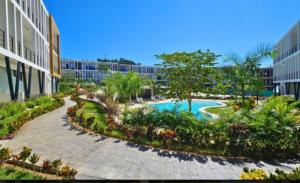a resort with a swimming pool and a building at Condo Mezcales in Mezcales