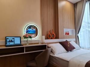 a bedroom with a bed and a desk with a laptop at An's Home in Hanoi +98 photos