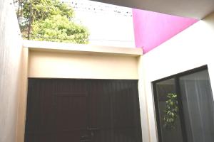 a garage with a black garage door on a building at Casa La Primavera RTH in Comitán de Domínguez