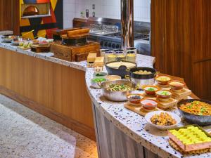 a buffet in a kitchen with many different types of food at Canopy By Hilton Osaka Umeda in Osaka
