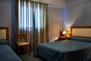 Tempat tidur dalam kamar di Blanro Hotel
