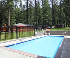 a large blue swimming pool in a yard at Eagle Cap Chalets in Joseph