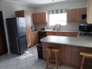 a kitchen with a refrigerator and a counter top at Cosy Haven Retreat in Sedgefield