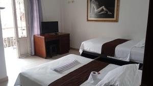 Postel nebo postele na pokoji v ubytování Hotel Tramonti
