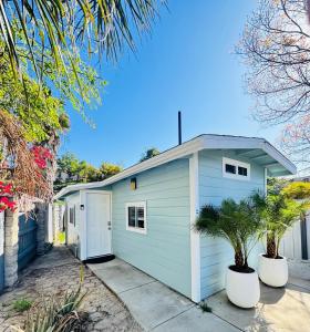 a white garage with two trees in front of it at Cozy Private Guesthouse with AC in Chula Vista