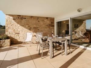 a dining room with a table and chairs on a patio at Carnac - Appartement 2 pièces - 4 pers - 65m² - Wifi - FR-1-477-258 in Carnac